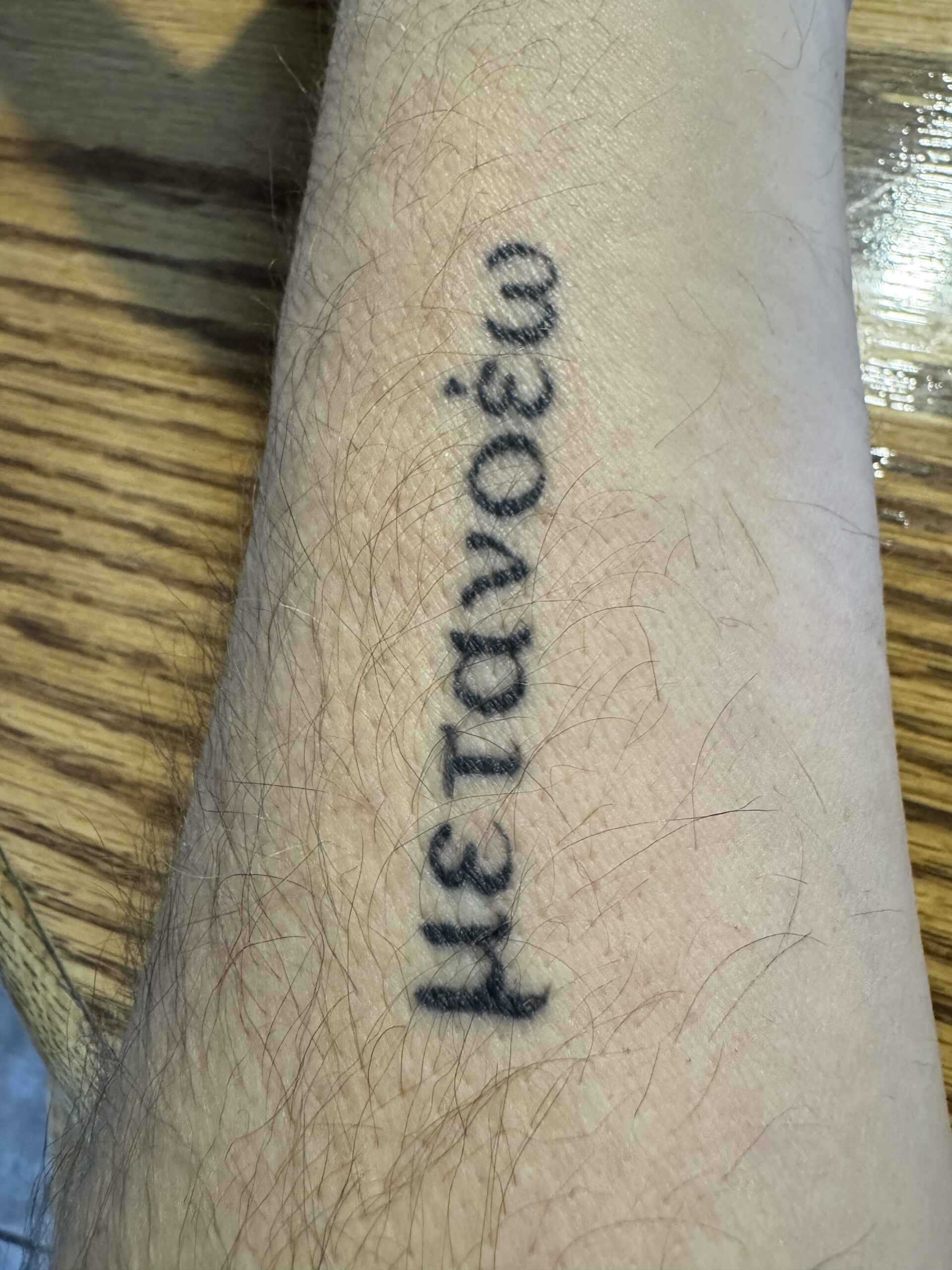 a picture of an arm with a tattoo that reads metanoia